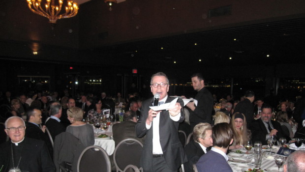 Parishioner and restaurateur Eugene Flinn leads the evening's auction.