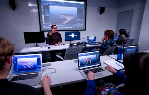 Assistant professor Nicholas O'Brien gives students a hand...